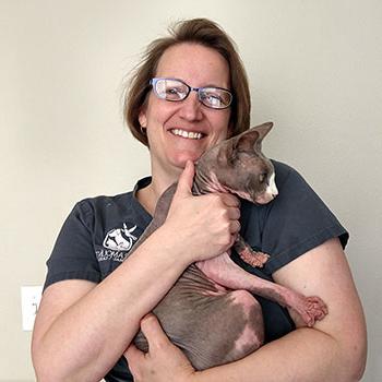 Iris Nigrin holding a hairless cat.