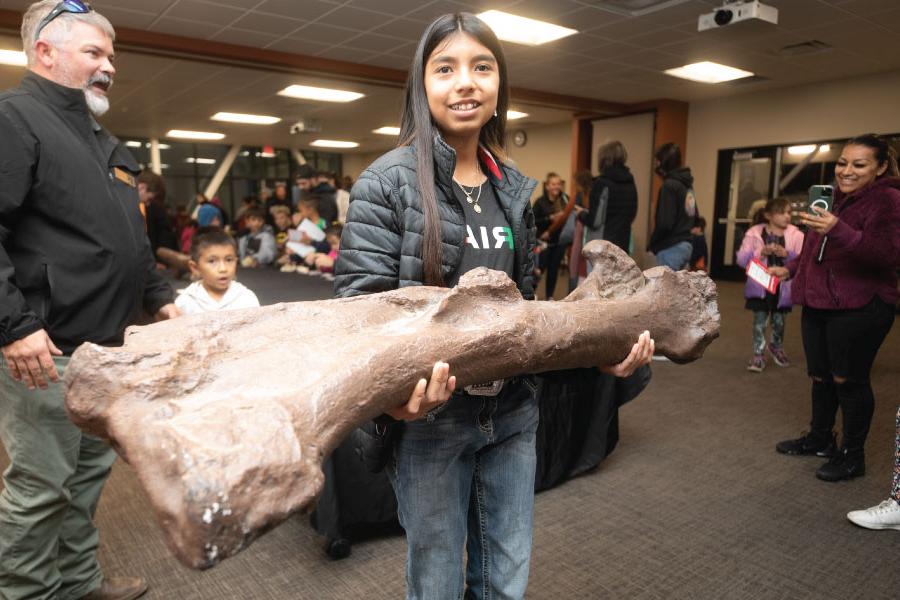 A Kids Kollege student holding a fossil in the Dugan Museum of Geology in the School of Energy!