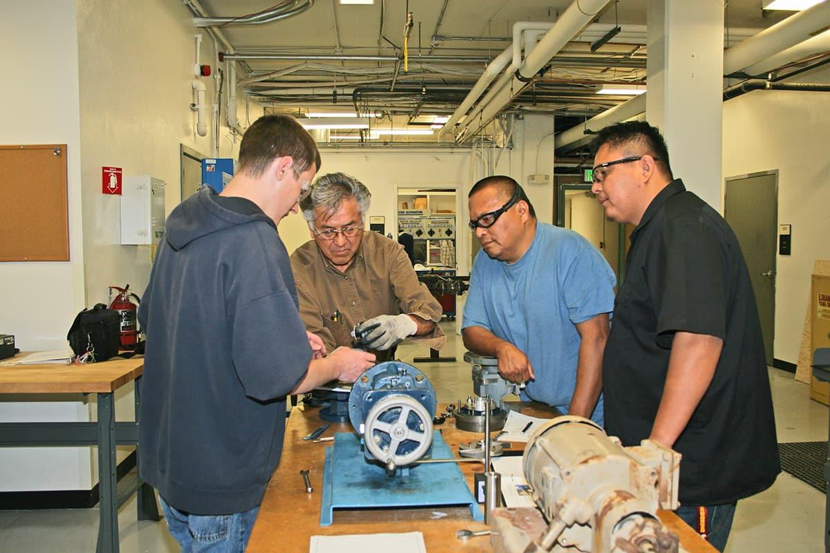 Students watch closely as instructor does a demonstration with some of the IMM equipment.