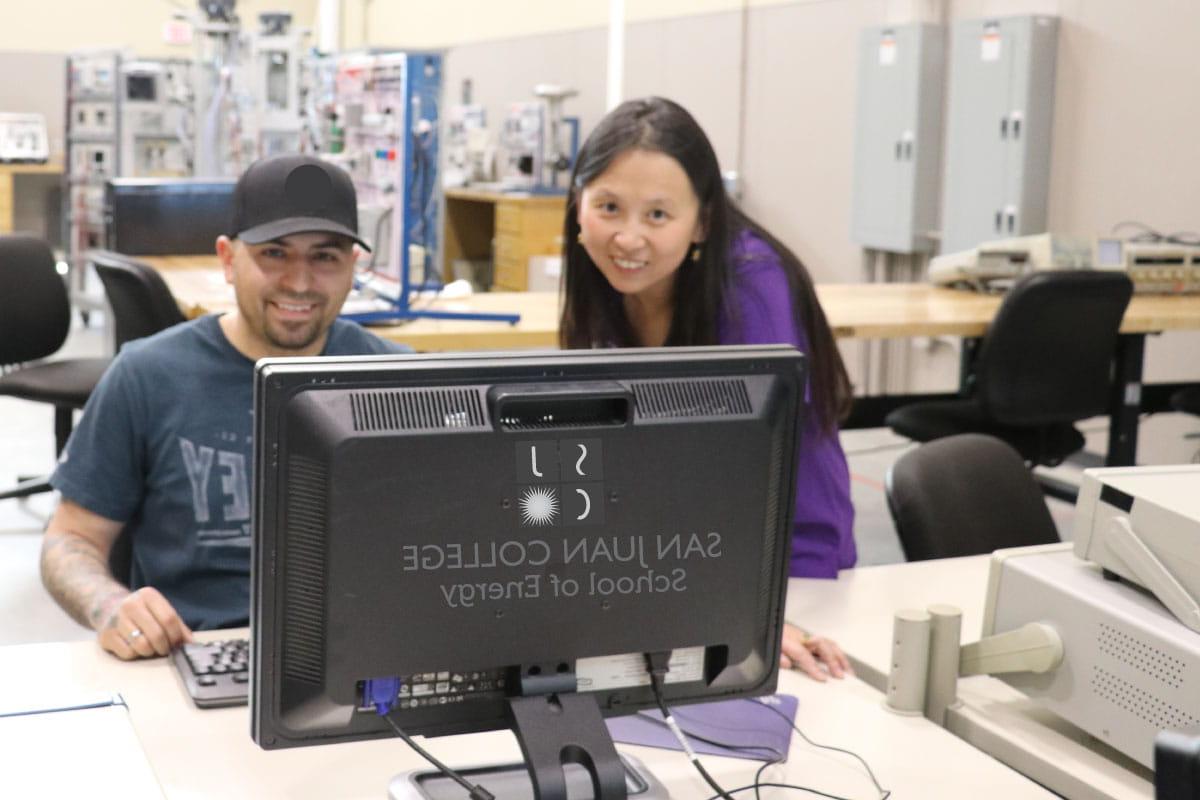 Two people looking at SJC School of Energy computer